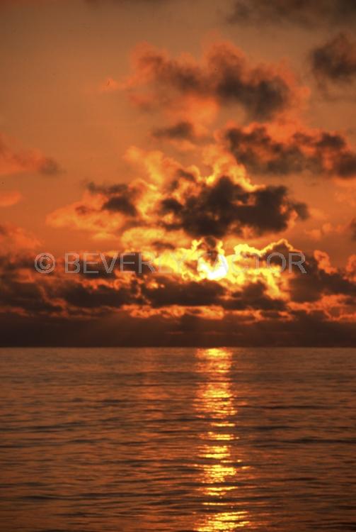 Islands;sunsets;sky;clouds;colorful;sun;yellow;water;red;Galapogos Island